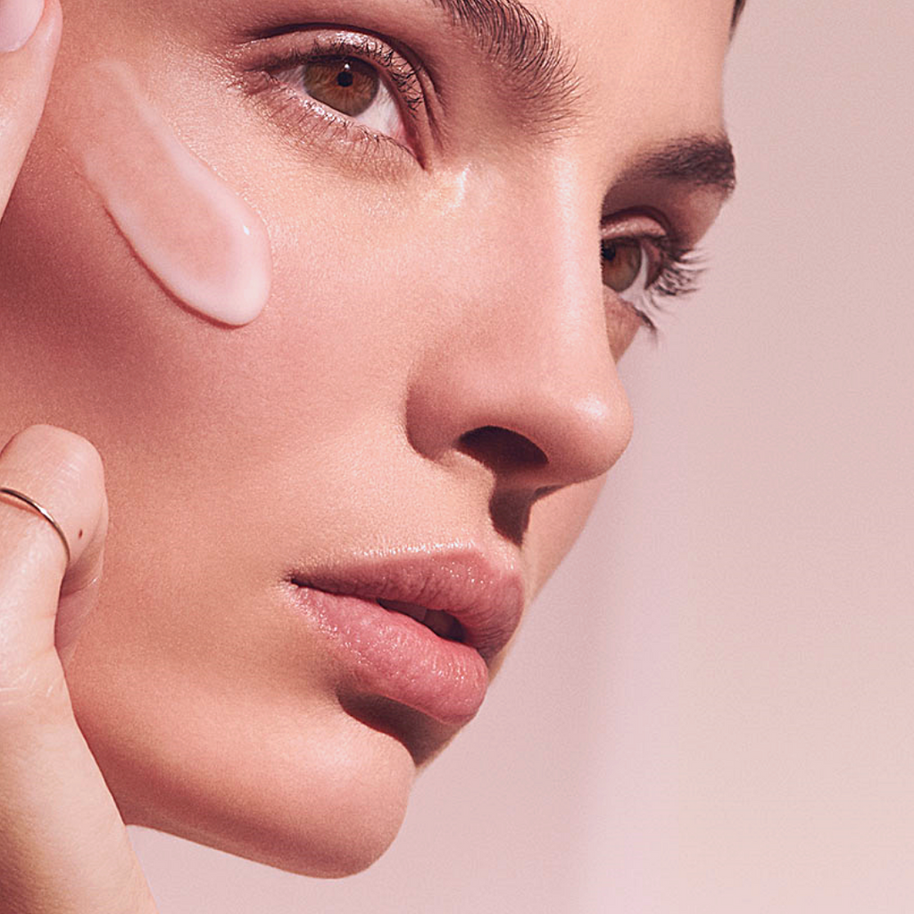 "model using skincare treatment to fight the signs of aging and improve clarity"